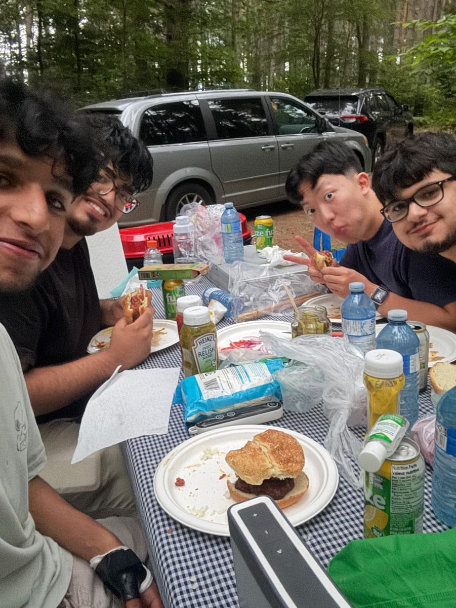 The same table from the other end, sandwiches and drinks spread across a checked cloth.