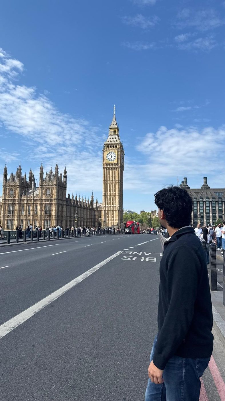 Standing on Westminster Bridge with Big Ben and the Houses of Parliament behind.